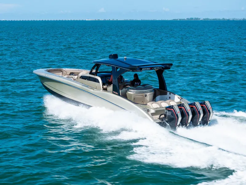 Slide: The Image of 2021 MTI V42 boat cruising on blue ocean waters with powerful engines. - 11