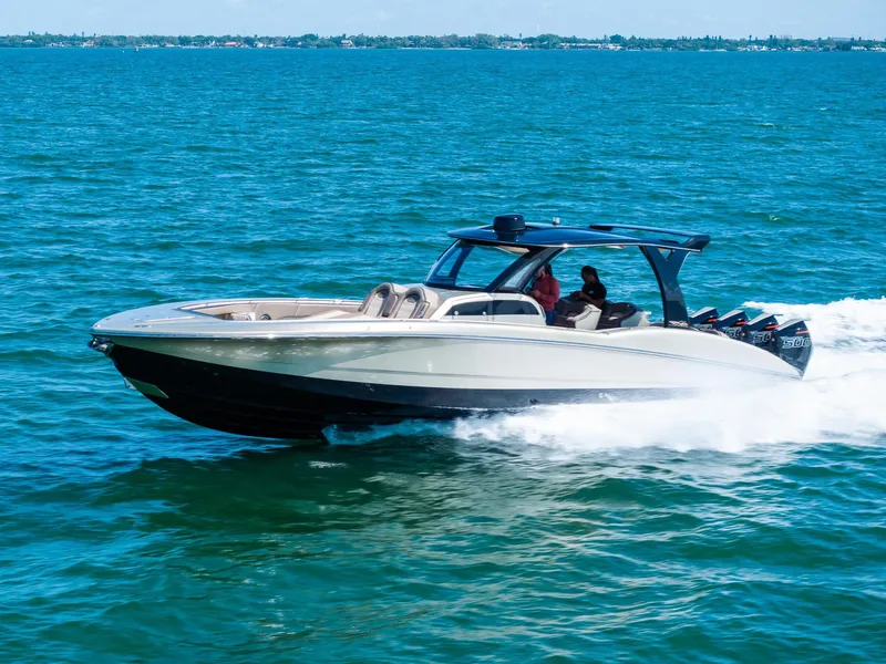 Slide: The Image of 2021 MTI V42 speedboat cruising on open water, showcasing sleek design and powerful engines. - 12