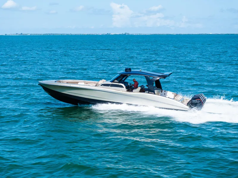 Slide: The Image of 2021 MTI V42 speedboat cruising on open blue water under a clear sky. - 13