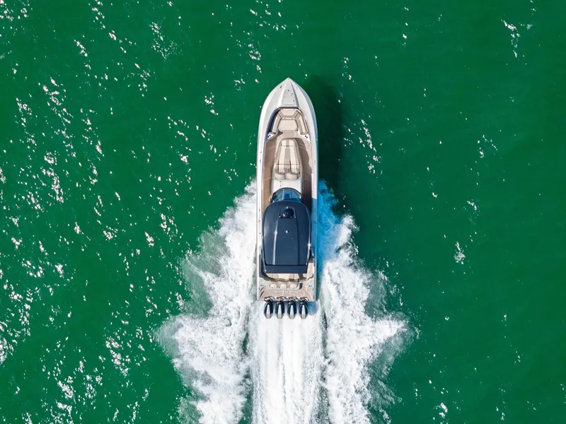 Slide: The Image of Aerial view of 2021 MTI V42 boat cruising on green water. - 15
