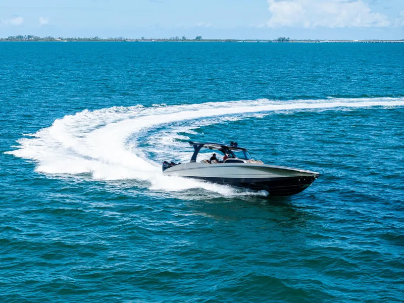 Slide: The Image of 2021 MTI V42 speedboat making a sharp turn on clear blue ocean waters. - 16