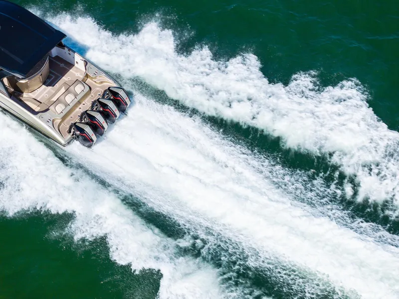 Slide: The Image of Aerial view of 2021 MTI V42 boat speeding on water, leaving a white wake. - 19