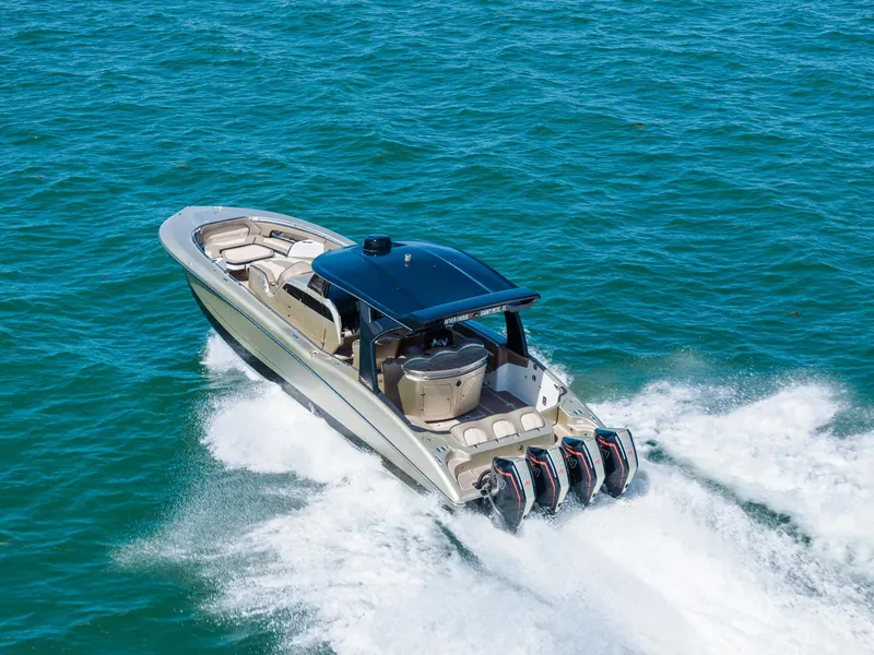 Slide: The Image of 2021 MTI V42 boat cruising on open water with powerful engines. - 21