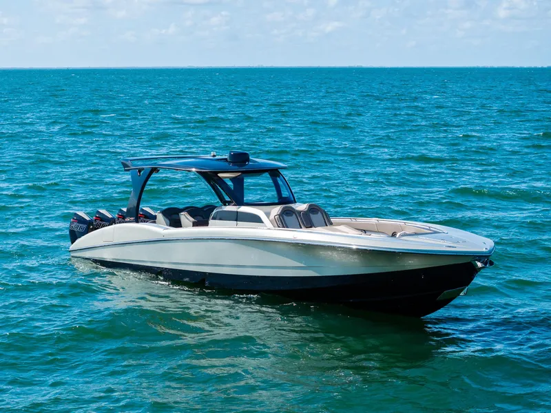 Slide: The Image of 2021 MTI V42 boat on open water under clear skies. - 3