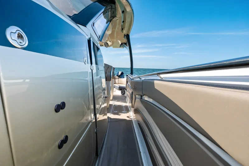 Slide: The Image of Luxury MTI V42 boat deck with sleek design, open sea view, and clear blue sky. - 31