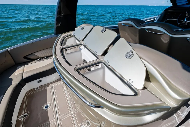 Slide: The Image of Luxury MTI V42 boat interior with open storage compartments, 2021 model, on a calm sea. - 33