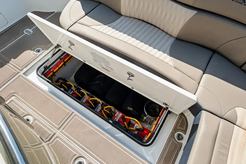Slide: The Image of 2021 MTI V42 boat storage compartment with open lid, revealing organized cables and equipment. - 36