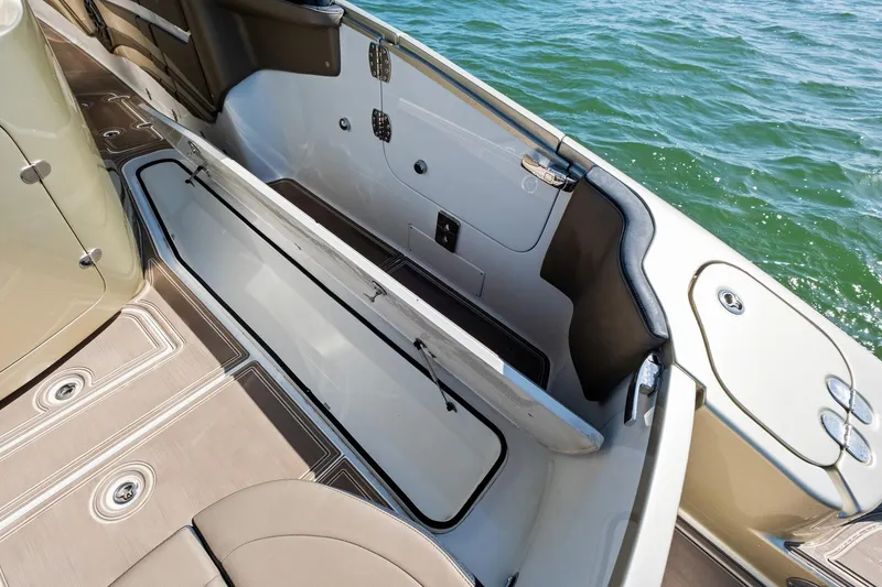 Slide: The Image of 2021 MTI V42 boat interior with open storage compartment, on calm water. - 44