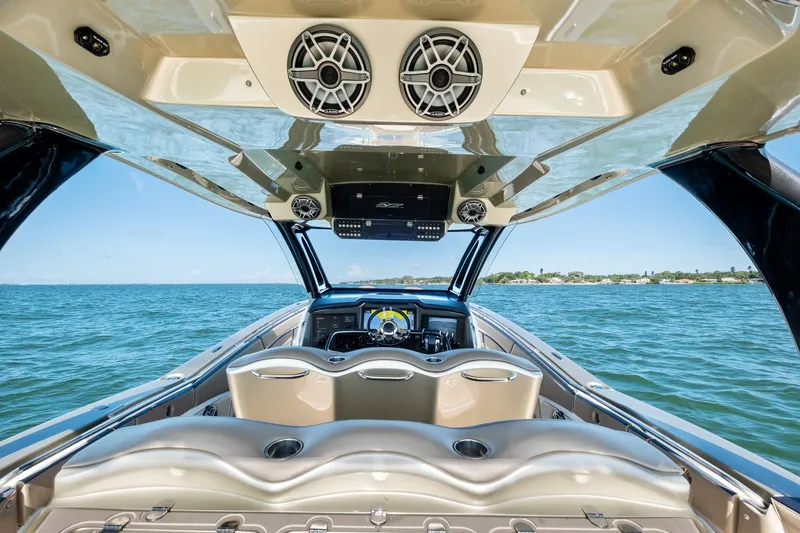 Slide: The Image of Luxury MTI V42 boat interior with ocean view, featuring modern seating and audio system, 2021 model. - 47