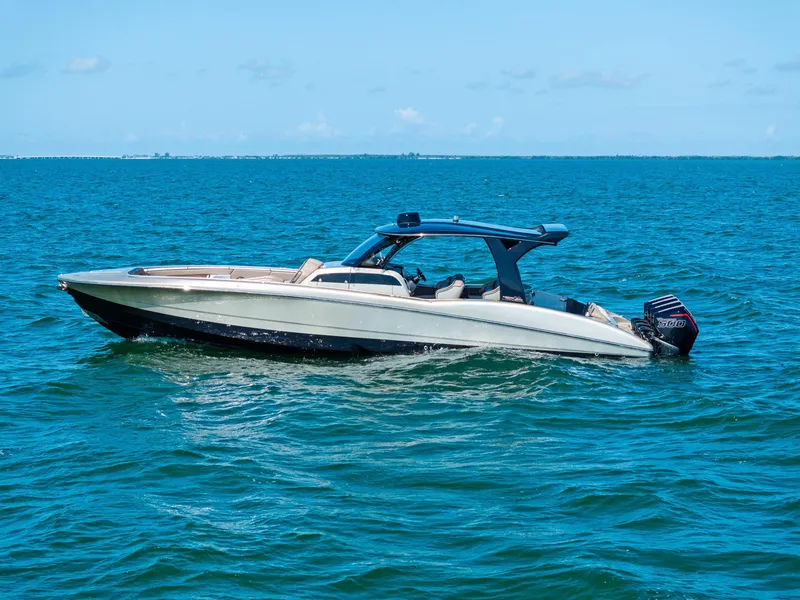 Slide: The Image of 2021 MTI V42 boat on open water under clear blue sky. - 5
