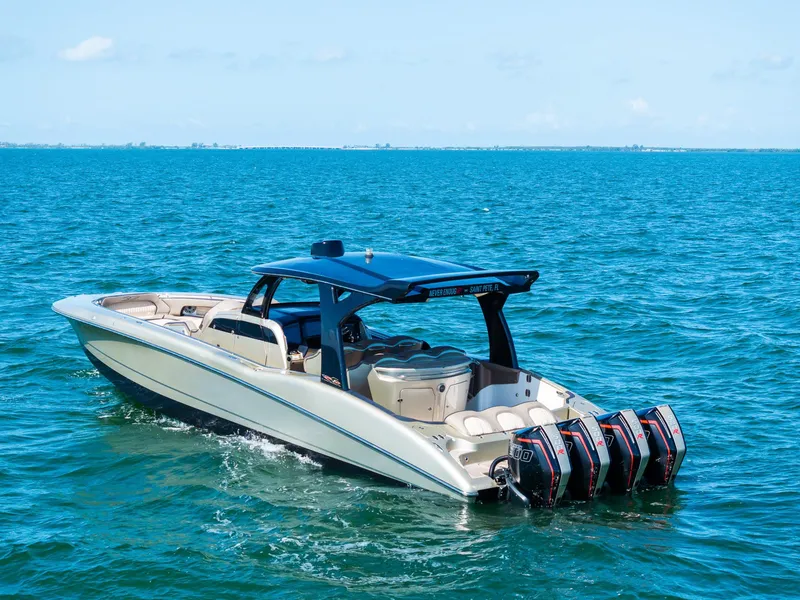 Slide: The Image of MTI V42 2021 boat cruising on open water with four powerful outboard engines. - 6