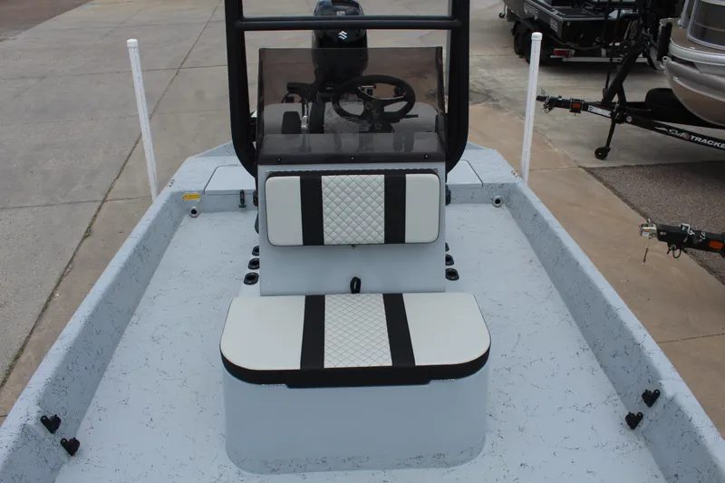 Slide: The Image of 2026 Freedom Boats EAGLE, light blue center console, equipped with rod holders, parked outdoors. - 13