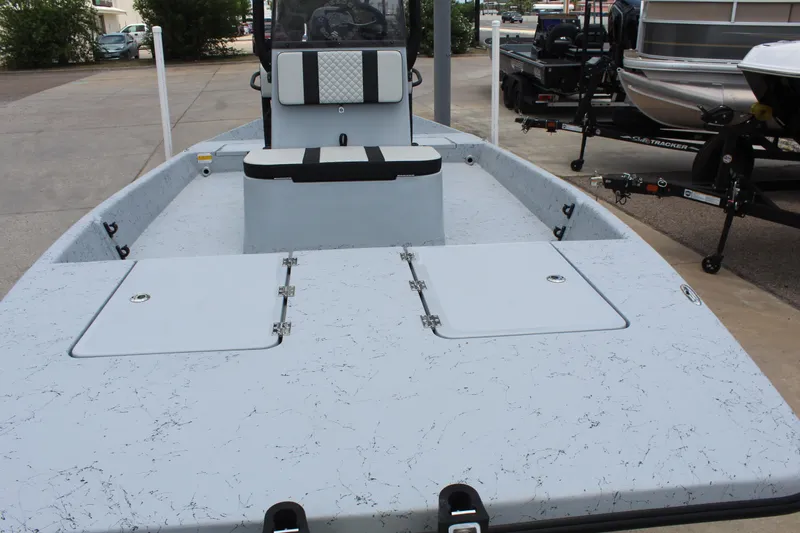 Slide: The Image of 2026 Freedom Boats EAGLE interior with blue and white seating and storage compartment. - 9