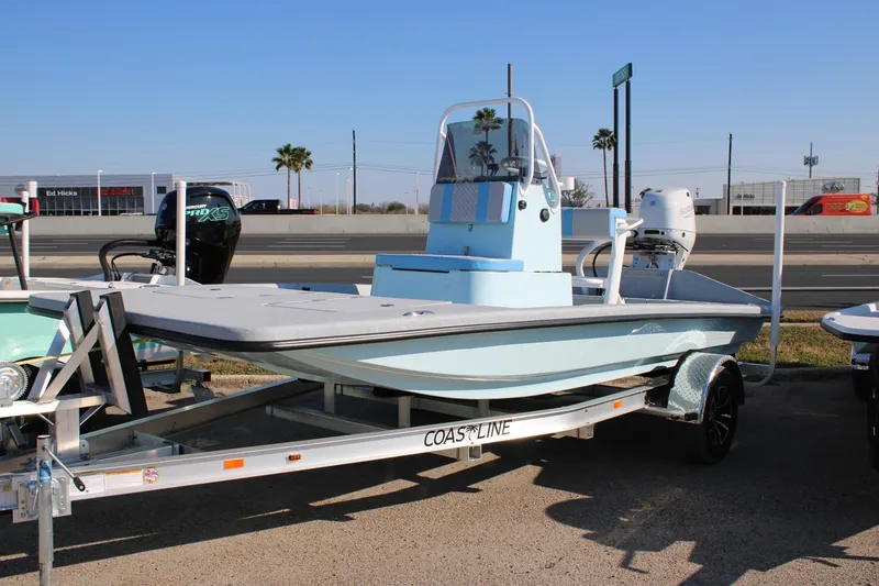 The Image of 2026 Freedom Boats EAGLE on trailer, light blue, parked outdoors. - 0