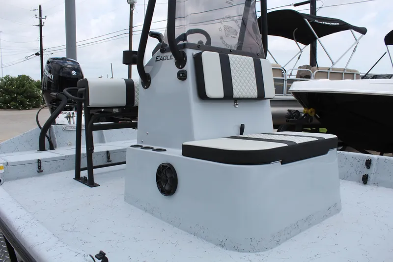 Slide: The Image of 2026 Freedom Boats EAGLE with blue and gray seating, parked on a trailer. - 10