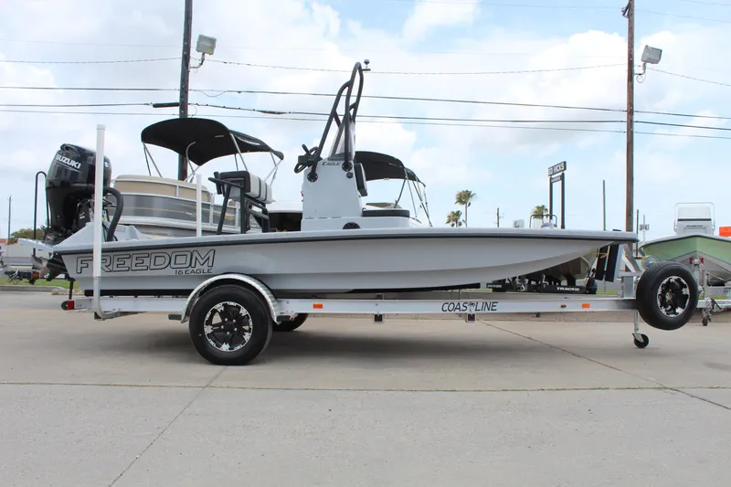 Slide: The Image of 2026 Freedom Boats EAGLE on trailer, showcasing rear view and motor details. - 4