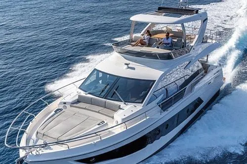 Slide: The Image of Luxurious 2023 Absolute Fly Co Ownership yacht cruising on open water. - 2