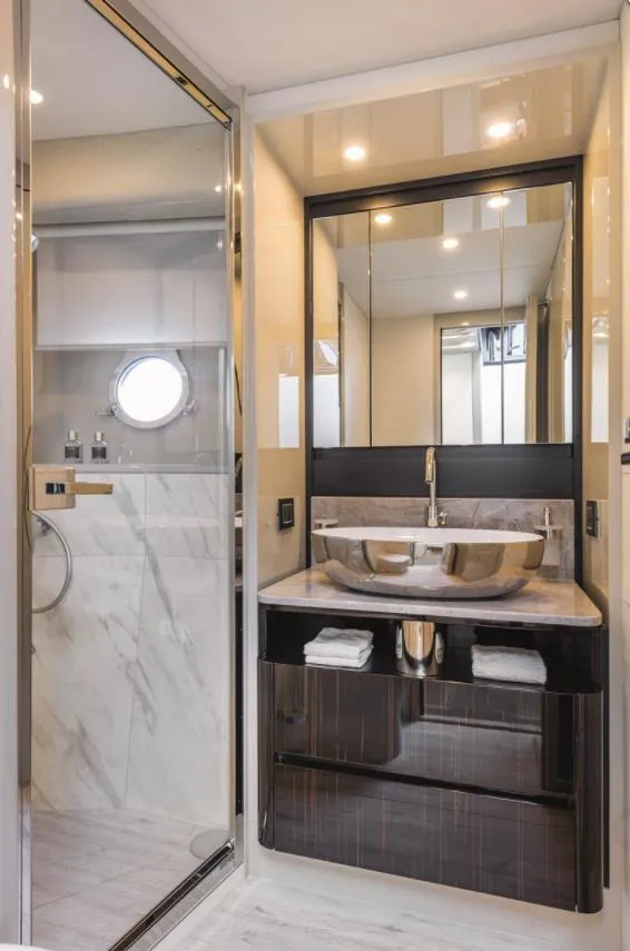 Slide: The Image of Luxurious yacht bathroom with dual sinks, modern fixtures, and elegant design, 2023 Absolute Fly Co Ownership. - 29