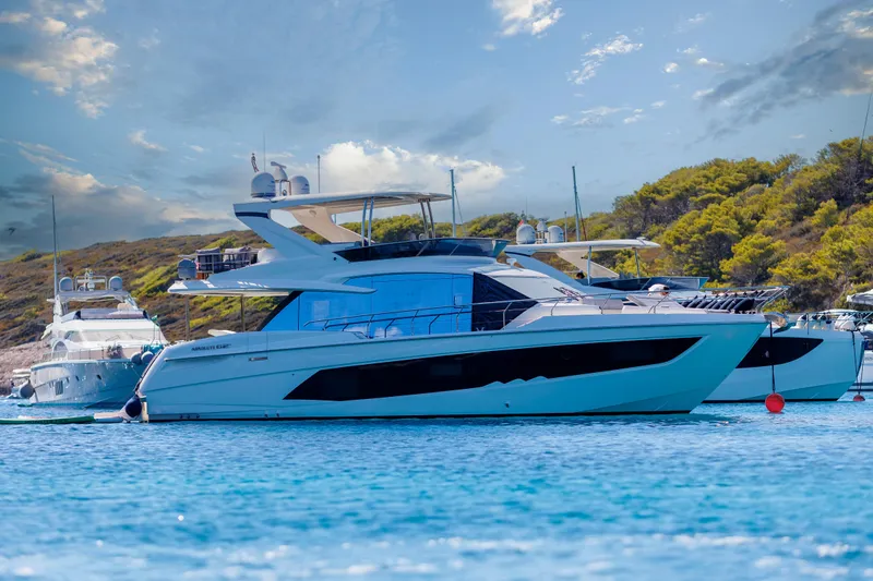Slide: The Image of Luxury yacht "Absolute Fly Co Ownership" 2023 on serene blue waters, scenic backdrop. - 1