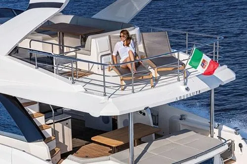 Slide: The Image of Luxury yacht Absolute Fly Co Ownership 2023 with woman relaxing on deck, Italian flag waving. - 10