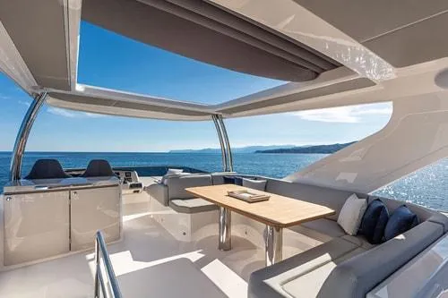 Slide: The Image of Luxurious 2023 Absolute Fly Co Ownership yacht interior with ocean view and elegant seating area. - 12