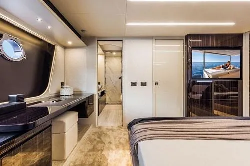 Slide: The Image of Luxurious yacht interior with modern design, featuring a bedroom, desk, and ocean view. Absolute Fly Co Ownership 2023. - 31