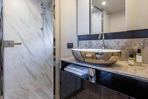 Slide: The Image of Luxurious yacht bathroom with marble shower, modern sink, and elegant decor, 2023 Absolute Fly Co Ownership. - 34