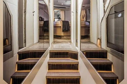 Slide: The Image of Luxurious yacht interior with elegant stairs, modern design, and ambient lighting, Absolute Fly Co Ownership 2023. - 38