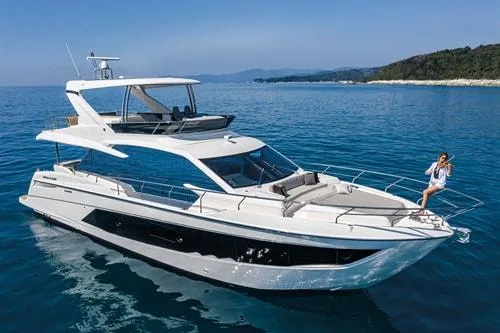 Slide: The Image of 2023 Absolute Fly Co Ownership yacht cruising on clear blue waters. - 4