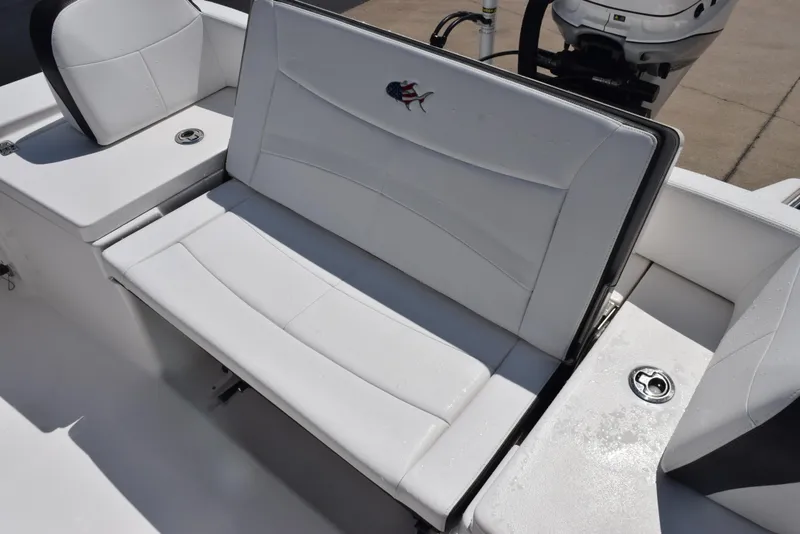 Slide: The Image of 2023 Crevalle 26 HCO boat with white cushioned seating and sleek design. - 13