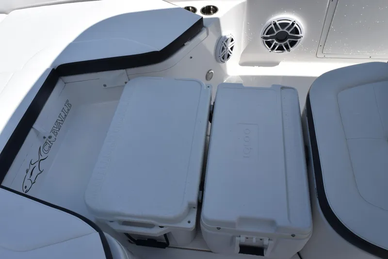 Slide: The Image of 2023 Crevalle 26 HCO boat interior with storage compartments and speakers. - 16