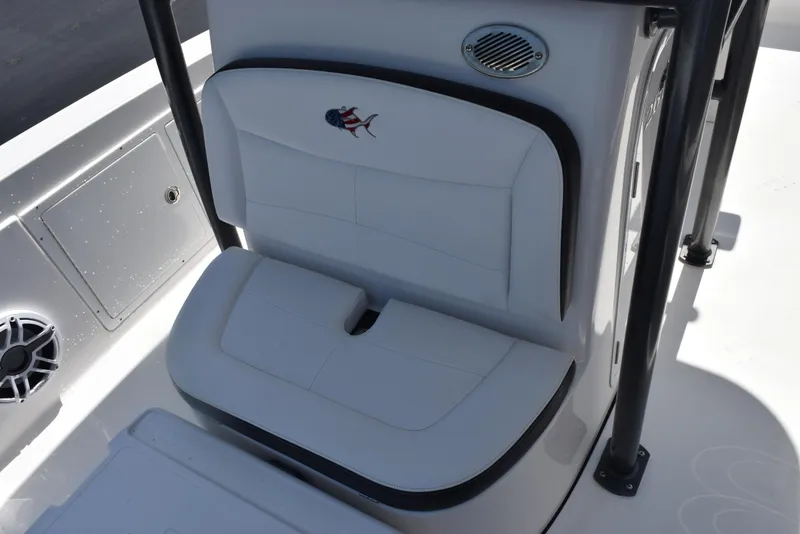 Slide: The Image of 2023 Crevalle 26 HCO boat seat with white cushioned design and speaker detail. - 17