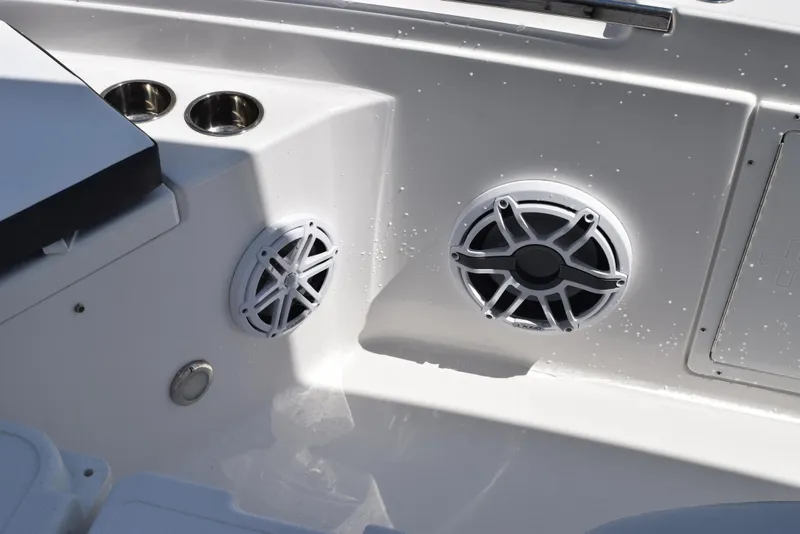 Slide: The Image of 2023 Crevalle 26 HCO boat interior with speakers and cup holders. - 18