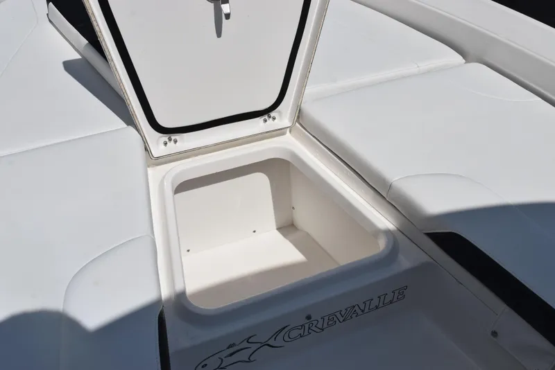 Slide: The Image of 2023 Crevalle 26 HCO boat storage compartment with open hatch, showcasing spacious interior. - 20