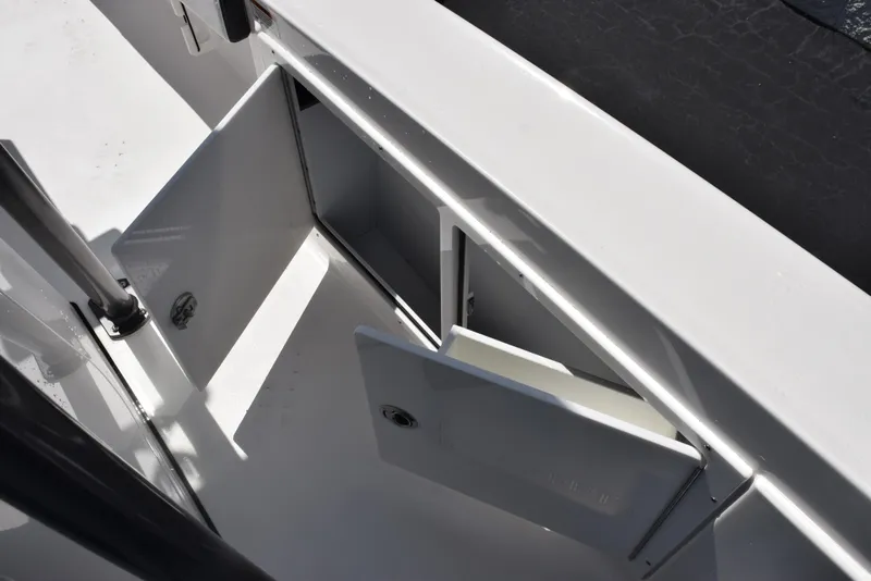 Slide: The Image of 2023 Crevalle 26 HCO boat storage compartments with open doors. - 21