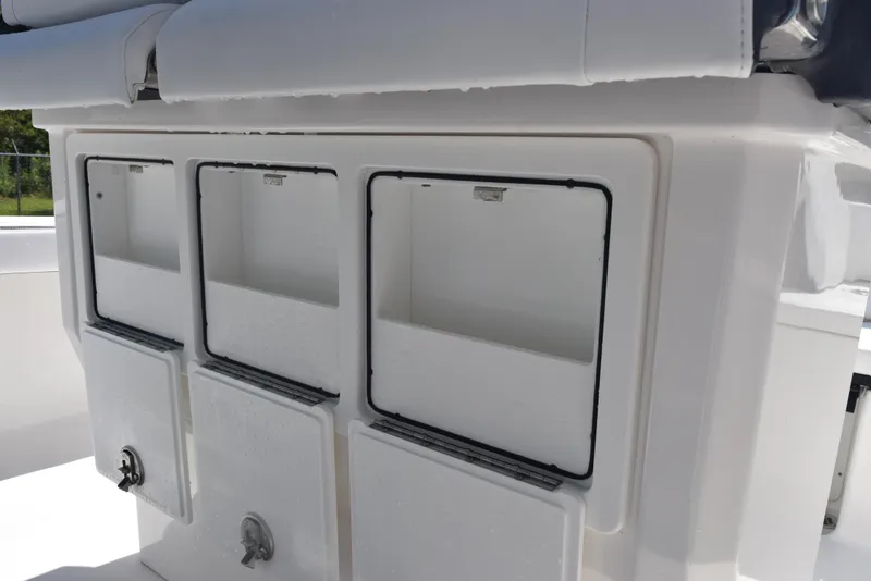Slide: The Image of 2023 Crevalle 26 HCO boat storage compartments, white interior, open hatches. - 24