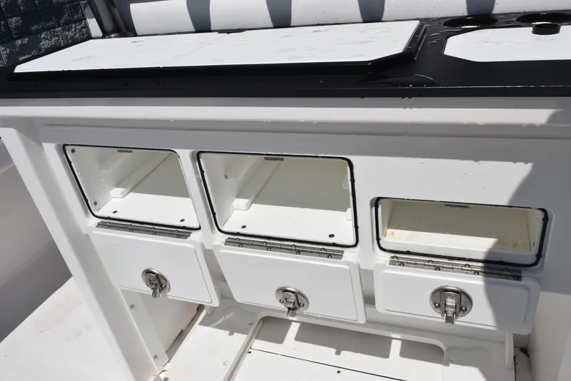 Slide: The Image of 2023 Crevalle 26 HCO boat storage compartments and drawers in white. - 25