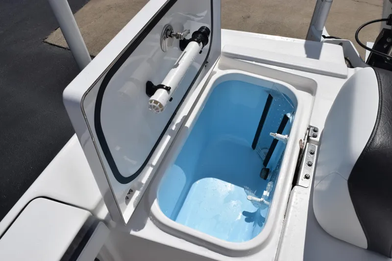 Slide: The Image of Livewell compartment on 2023 Crevalle 26 HCO boat, open lid, blue interior. - 26