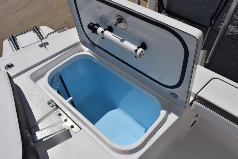 Slide: The Image of 2023 Crevalle 26 HCO boat livewell with open lid, showcasing interior design. - 27