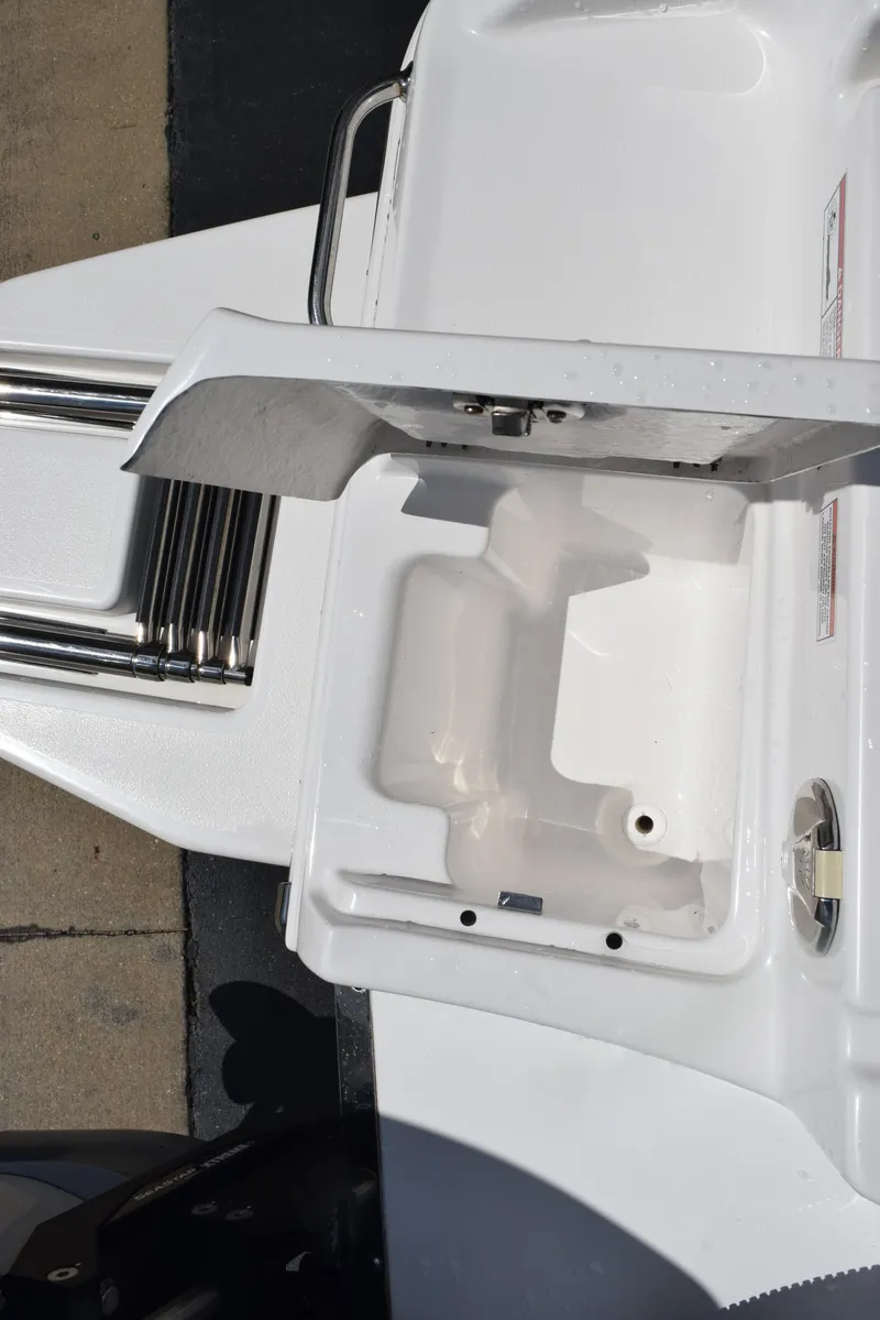 Slide: The Image of 2023 Crevalle 26 HCO boat compartment with open lid, showcasing interior details. - 28