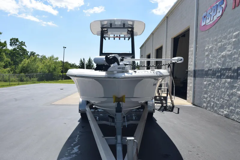 Slide: The Image of 2023 Crevalle 26 HCO boat on trailer outside a building under a clear sky. - 3