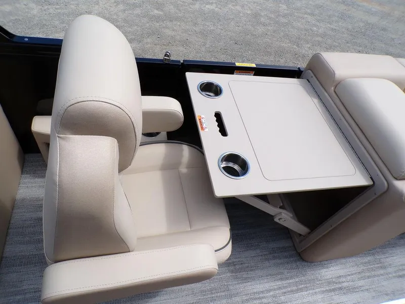 Slide: The Image of Beige seating and table with cup holders on 2025 Godfrey Sweetwater 2286 SB boat. - 5