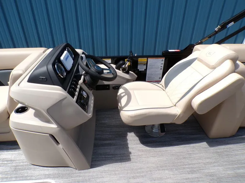Slide: The Image of 2025 Godfrey Sweetwater 2286 SB boat interior with beige captain's chair and control console. - 6