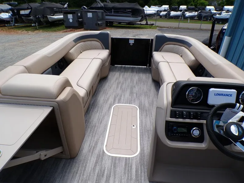 Slide: The Image of 2025 Godfrey Sweetwater 2286 SB boat interior with beige seating and modern dashboard. - 8