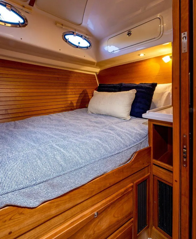 Slide: The Image of Cozy cabin interior of 2026 Back Cove 372 yacht with wooden accents and comfortable bedding. - 13