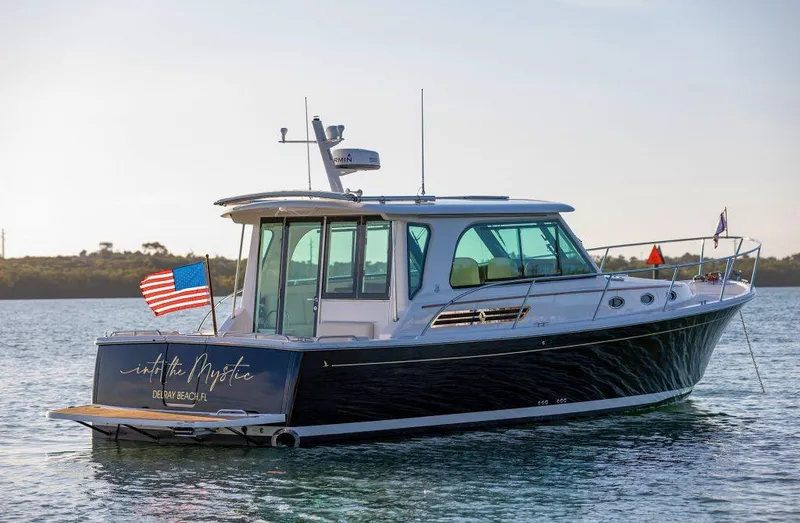 Slide: The Image of Back Cove 372 boat, 2026 model, on calm water with American flag. - 15