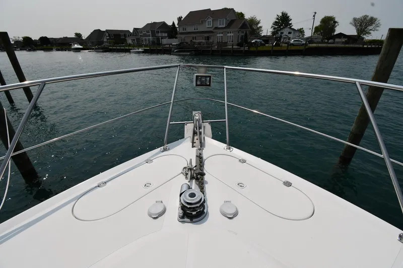 Slide: The Image of Bow view of 1998 Carver 530 Voyager Pilothouse, docked near waterfront homes. - 3