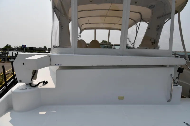 Slide: The Image of 1998 Carver 530 Voyager Pilothouse yacht, featuring a spacious deck and covered seating area. - 32