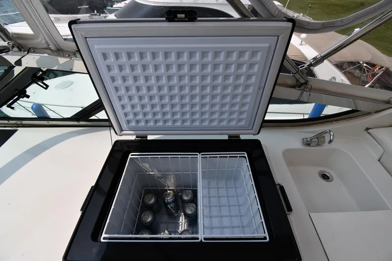 Slide: The Image of Open cooler with drinks on 1998 Carver 530 Voyager Pilothouse yacht deck. - 34