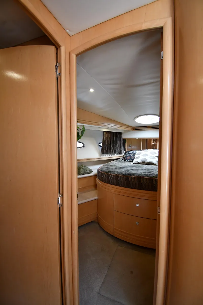 Slide: The Image of 1998 Carver 530 Voyager Pilothouse bedroom with circular bed and wooden interior. - 38
